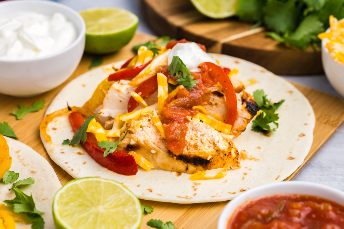 angled shot of grilled chicken fajita board