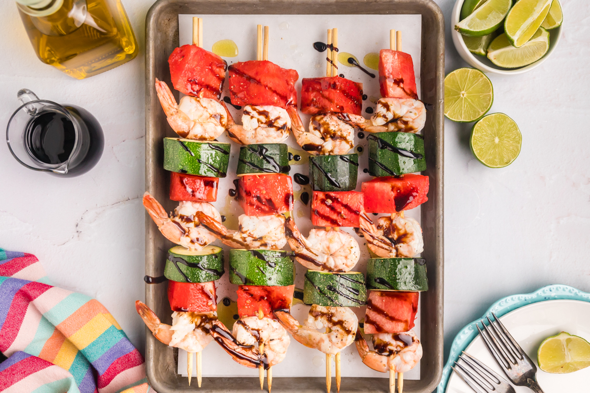 overhead shot of watermelon shrimp kabobs on sheet pan