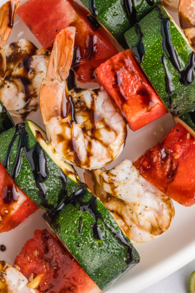 close up overhead shot of platter of grilled watermelon shrimp kabobs