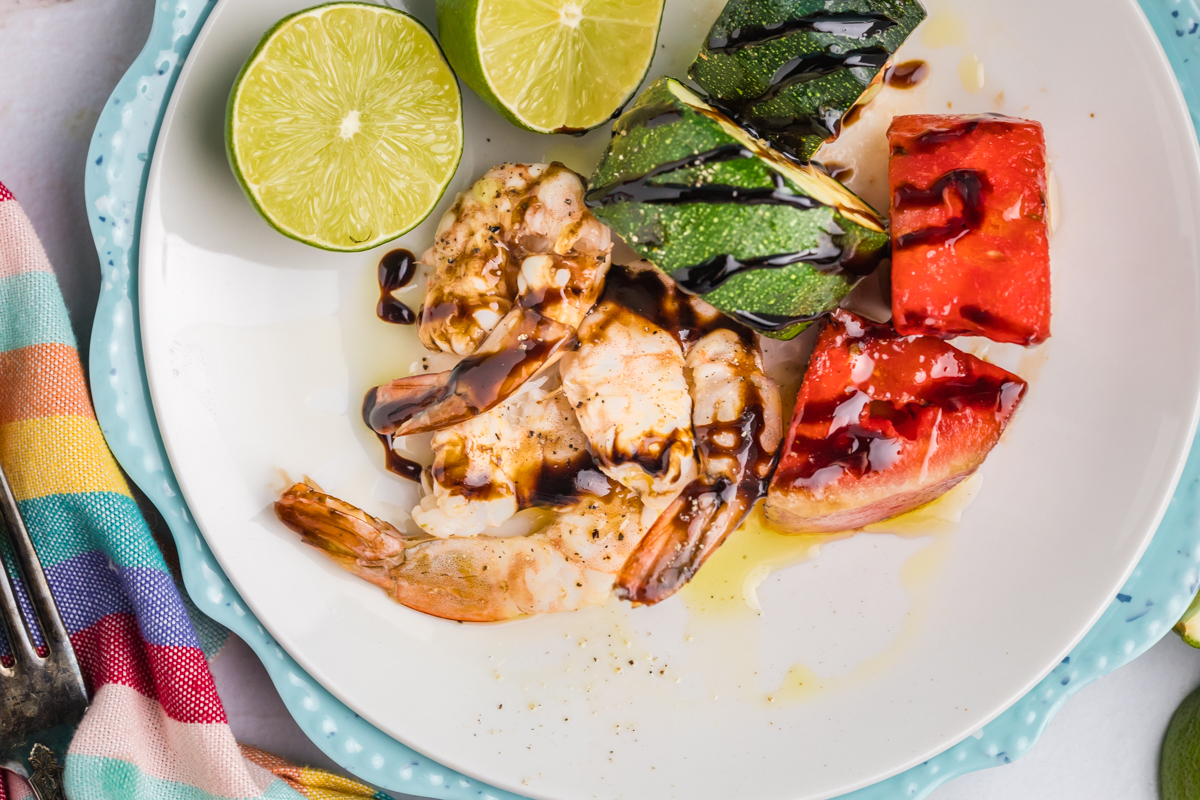 close up overhead shot of grilled watermelon, shrimp and zucchini on plate