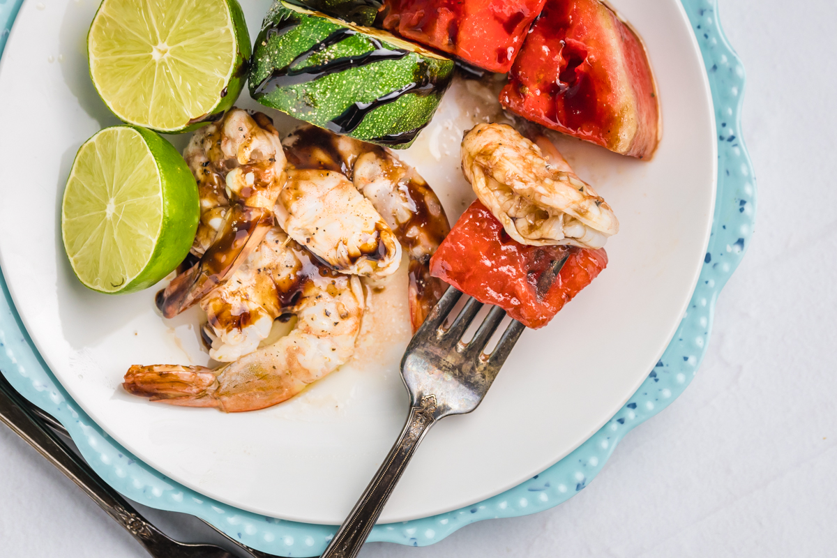 overhead shot of grilled watermelon and shrimp on fork