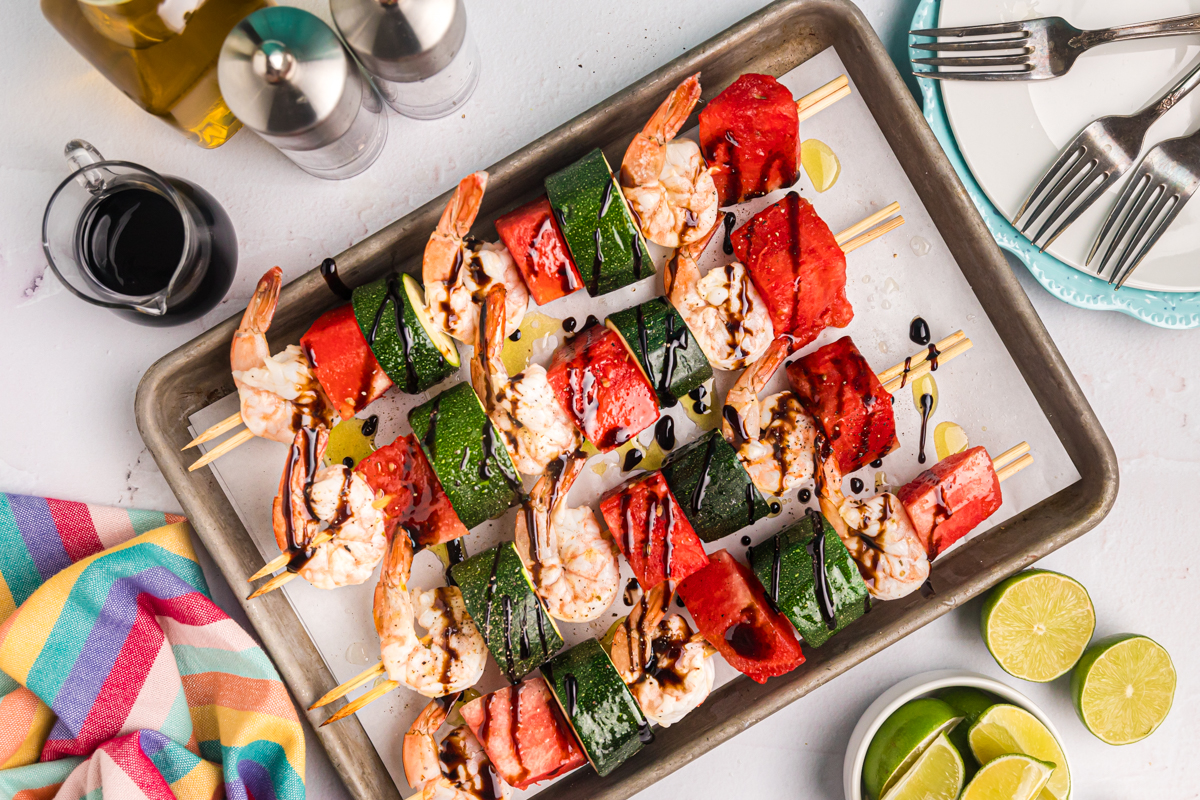 overhead shot of grilled watermelon shrimp kabobs on sheet pan