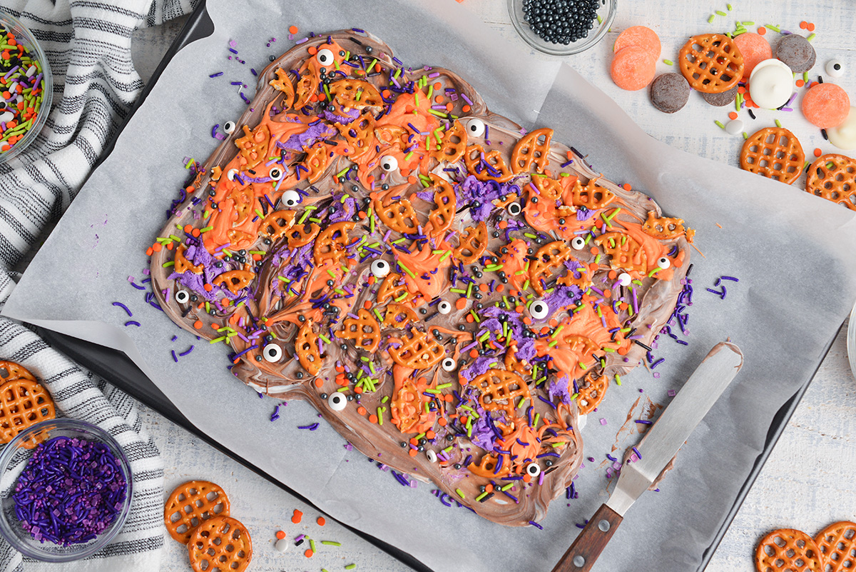 halloween bark toppings added to melted chocolate