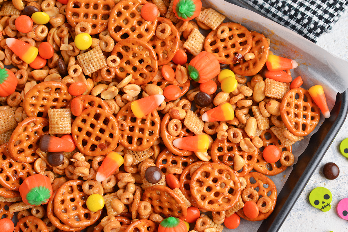 close up of honey nut snack mix on a baking sheet