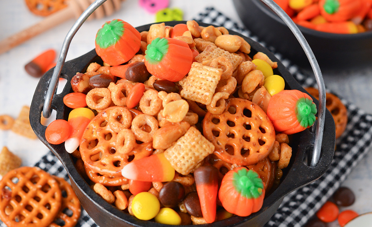 close up of snack mix with candy corn and reeses pieces