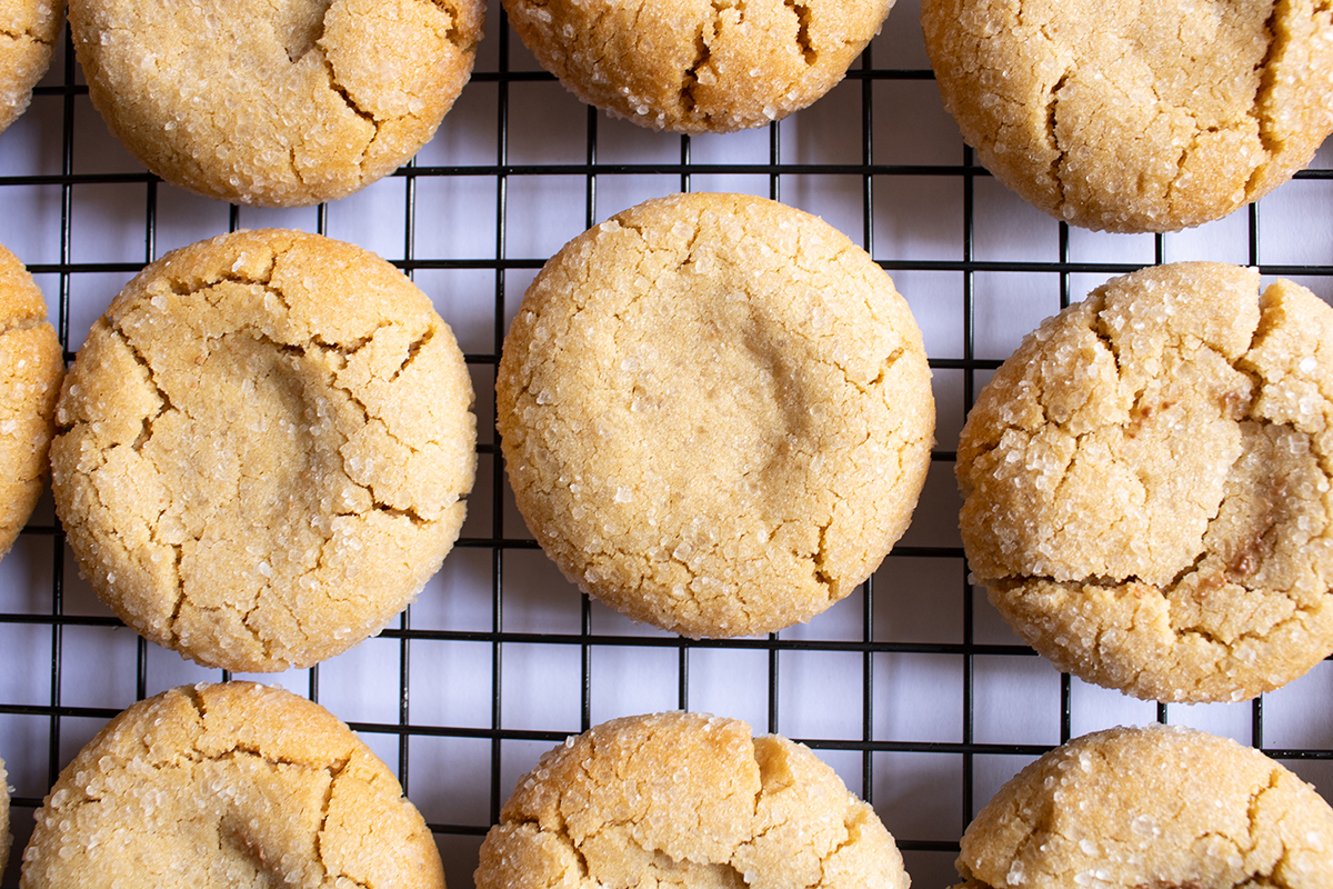 overhead shot of baked peanut butter cookies on cooling rack