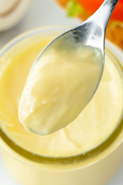 close up overhead shot of spoon full of mayo