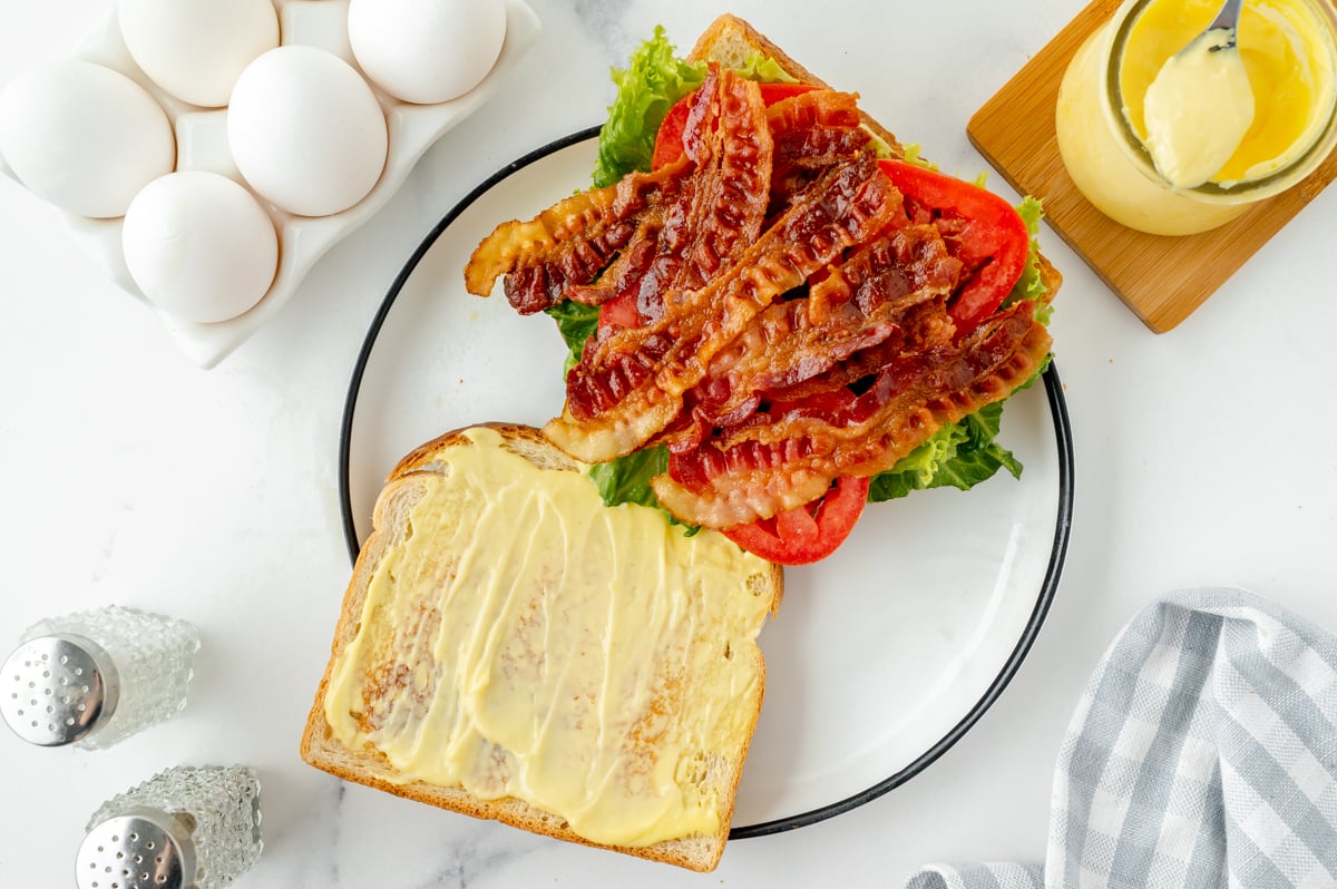 overhead shot of open faced blt sandwich on plate