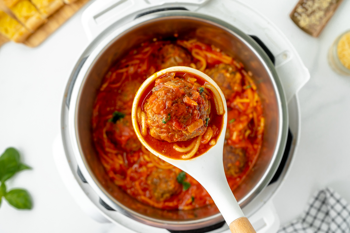 overhead shot of ladle of instant pot spaghetti and meatballs