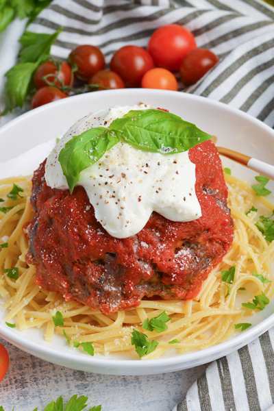 angled shot of lavo one pound meatball over pasta in bowl