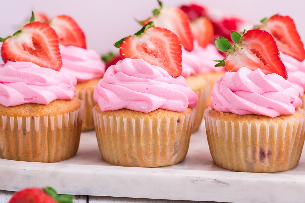 straight on shot of tray of lemon strawberry cupcakes