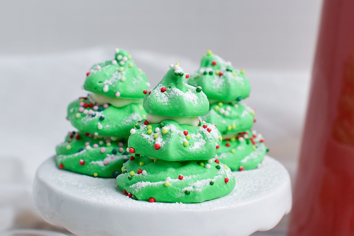 close up of meringue christmas trees with powdered sugar "snow" dusting