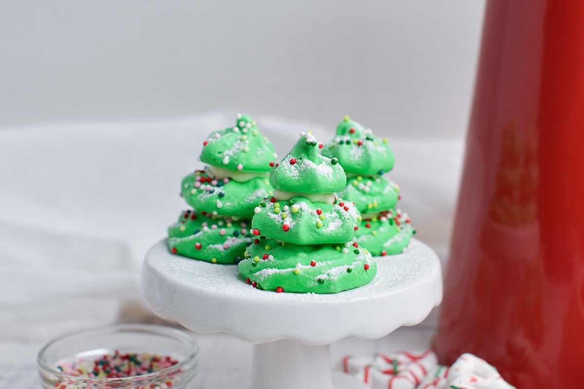 close up of three homemade candy christmas trees on a white cake stand