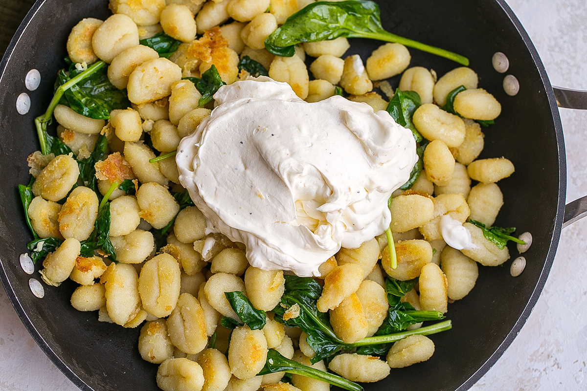 sauce added to pan of gnocchi