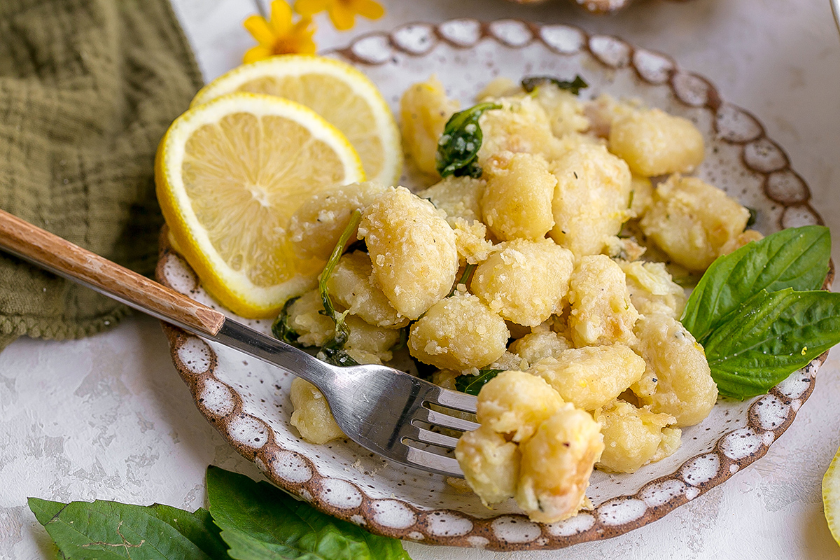 angled shot of bite of gnocchi on fork