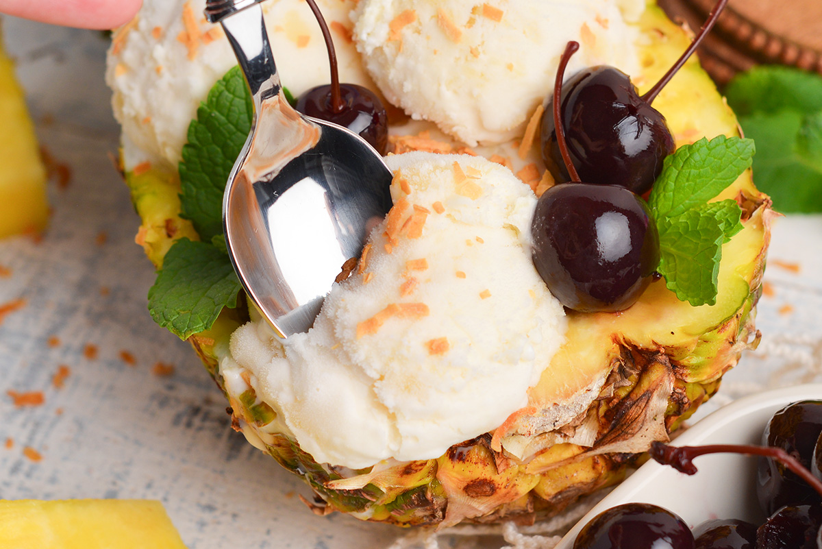 close up of spoon digging into pina colada ice cream