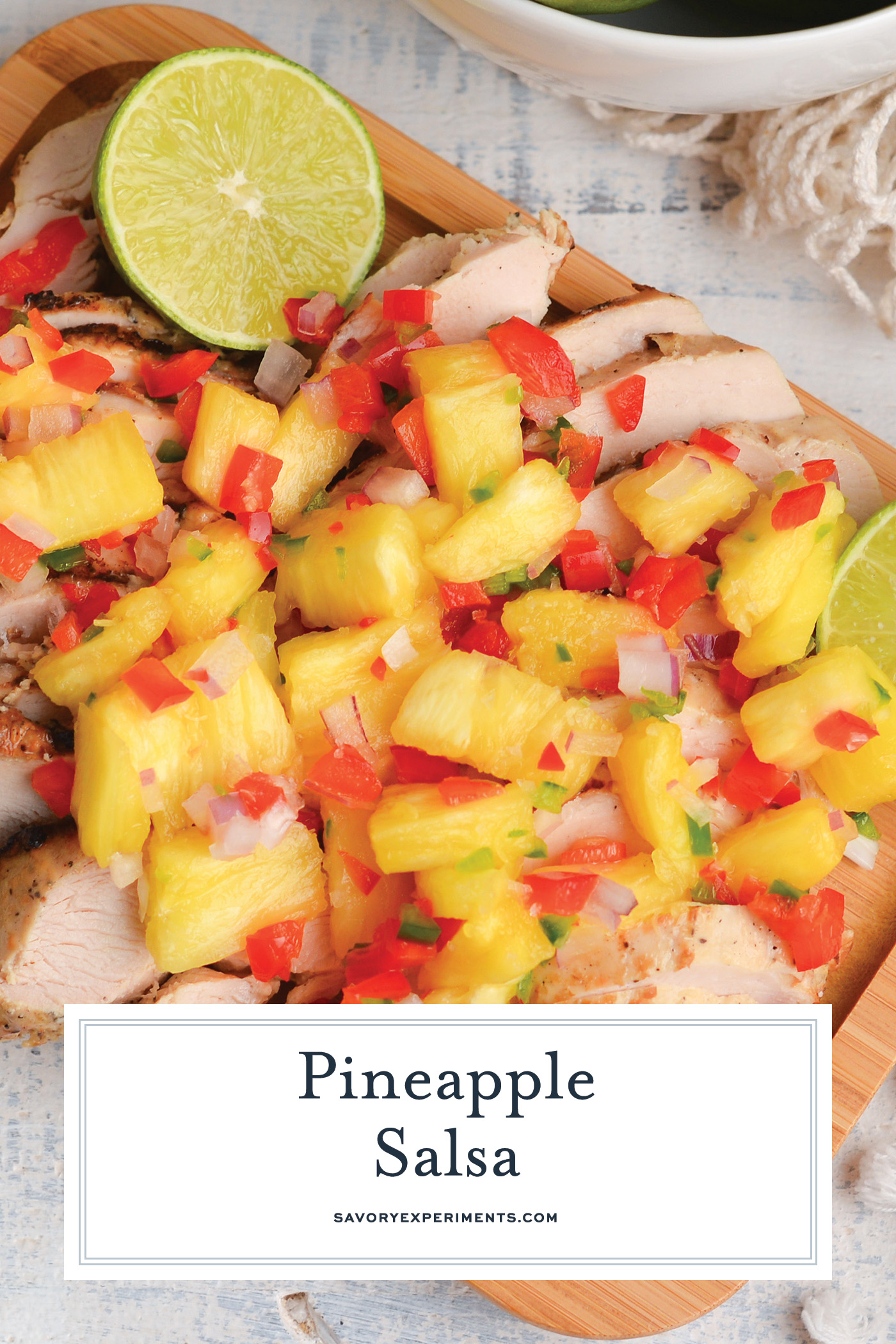 pineapple salsa over chicken with text overlay