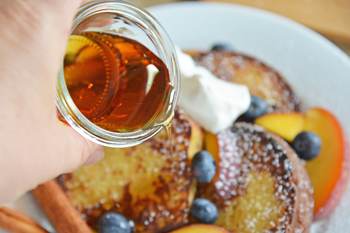 maple syrup pouring over fresh french toast