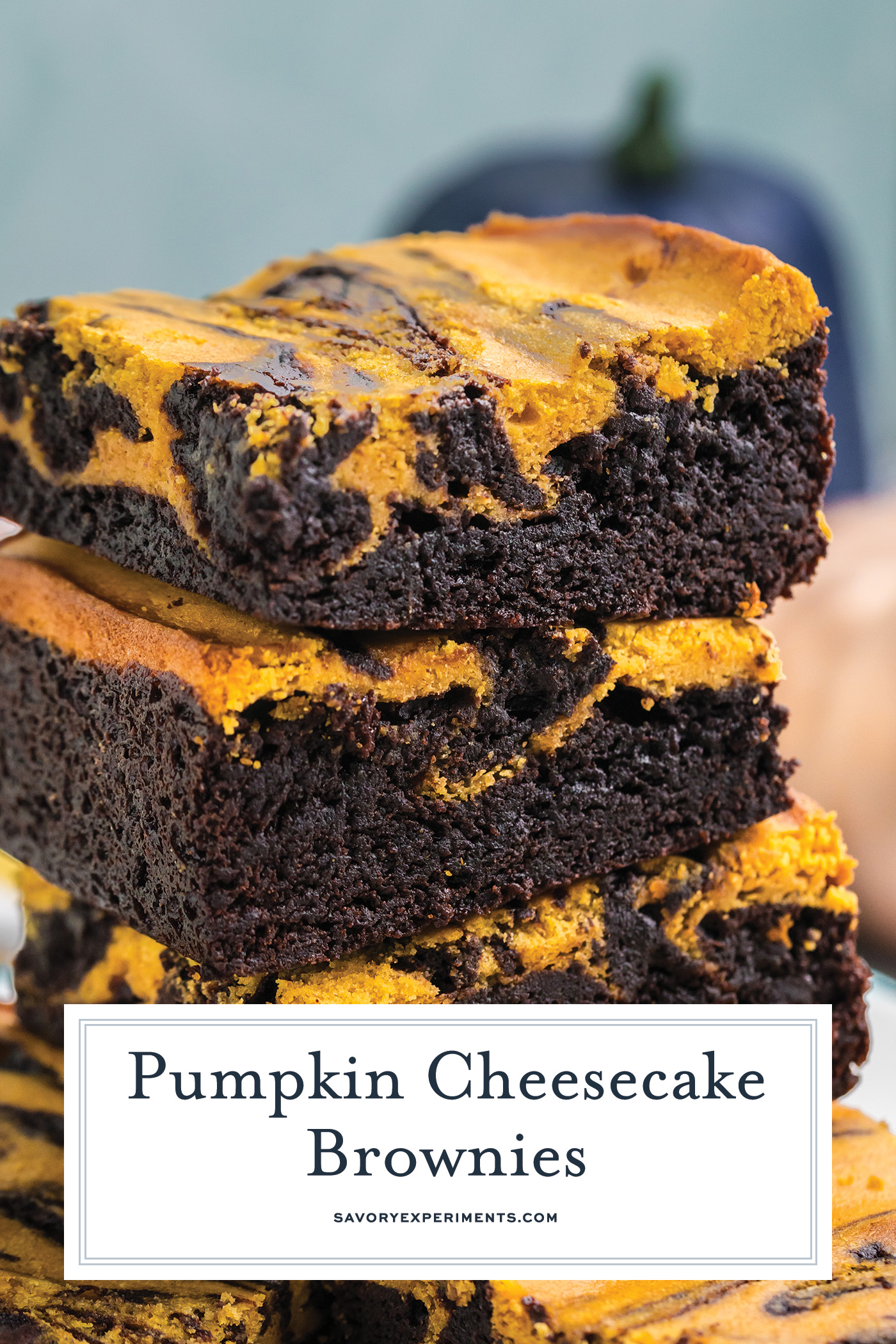 stack of pumpkin cheesecake brownies with text overlay