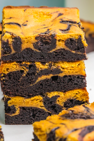 stack of three pumpkin cheesecake brownies