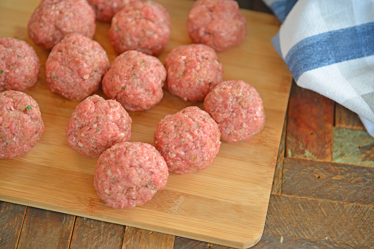 raw ranch meatballs on a wood cutting board