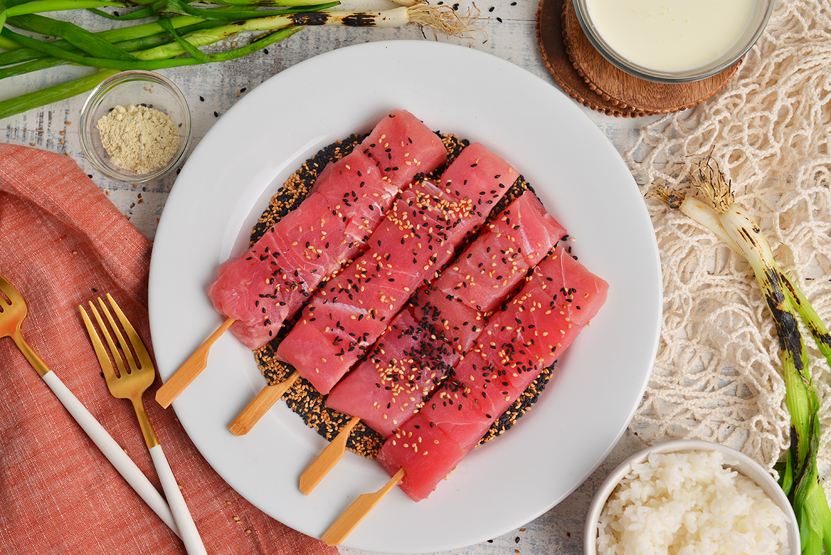 tuna sticks on plate of sesame seeds