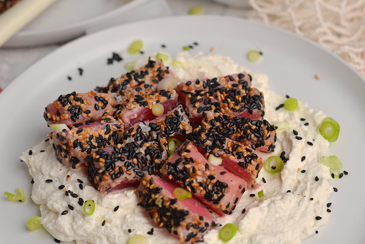 angled shot of plate of sliced sesame crusted tuna