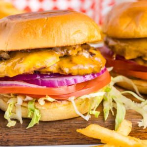 straight on shot of two smash burgers on wooden board