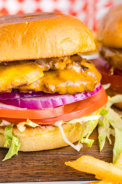 straight on shot of two smash burgers on wooden board