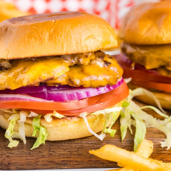 straight on shot of two smash burgers on wooden board