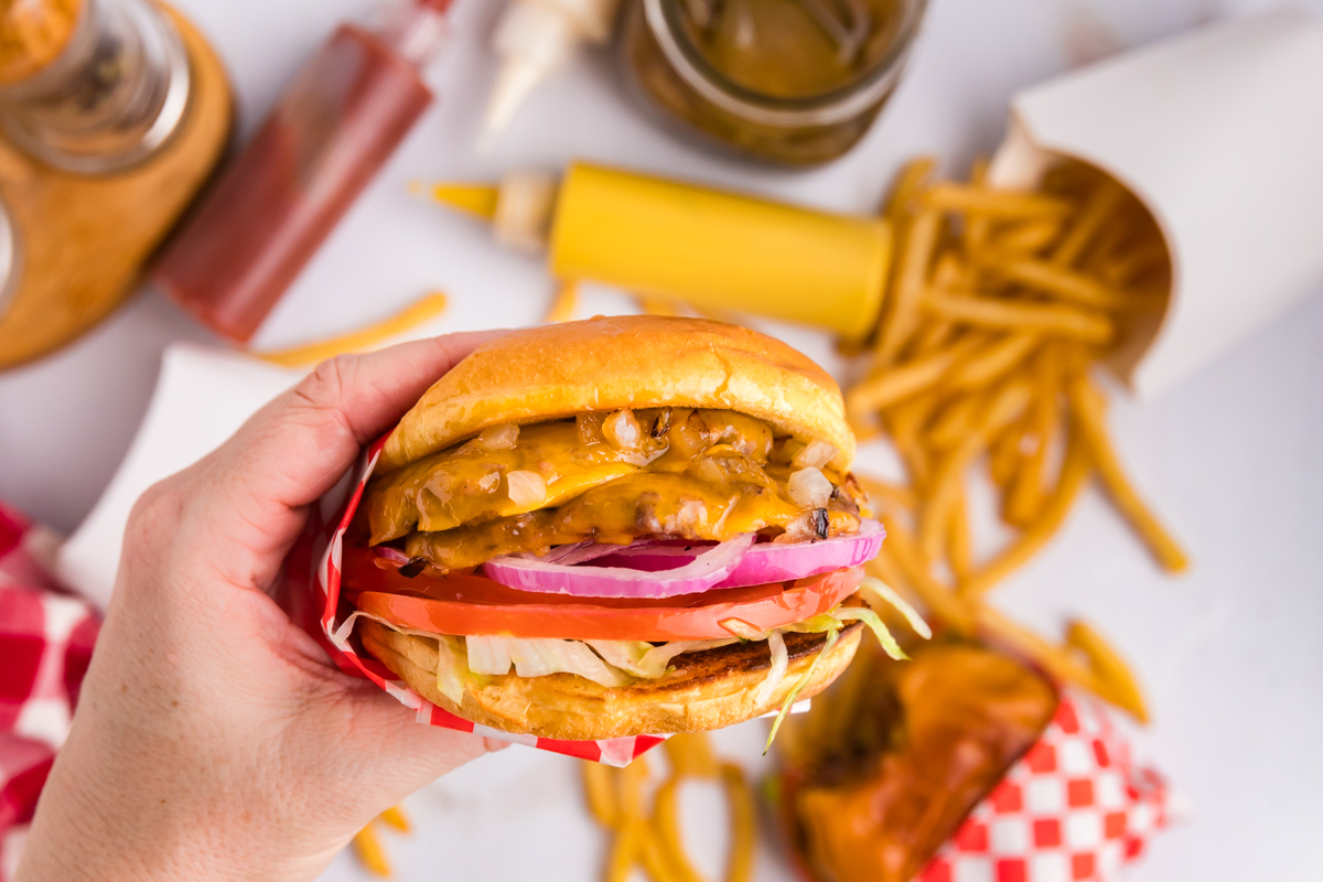 overhead shot of hand holding smash burger