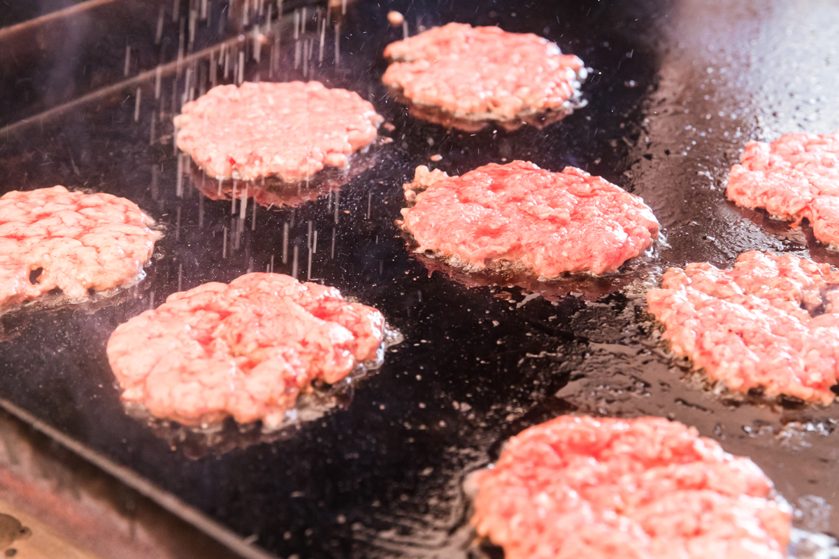 burger patties cooking on grill