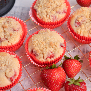 angled shot of strawberry muffins on cooling rack