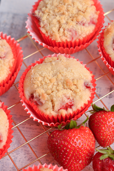 angled shot of strawberry muffins on cooling rack