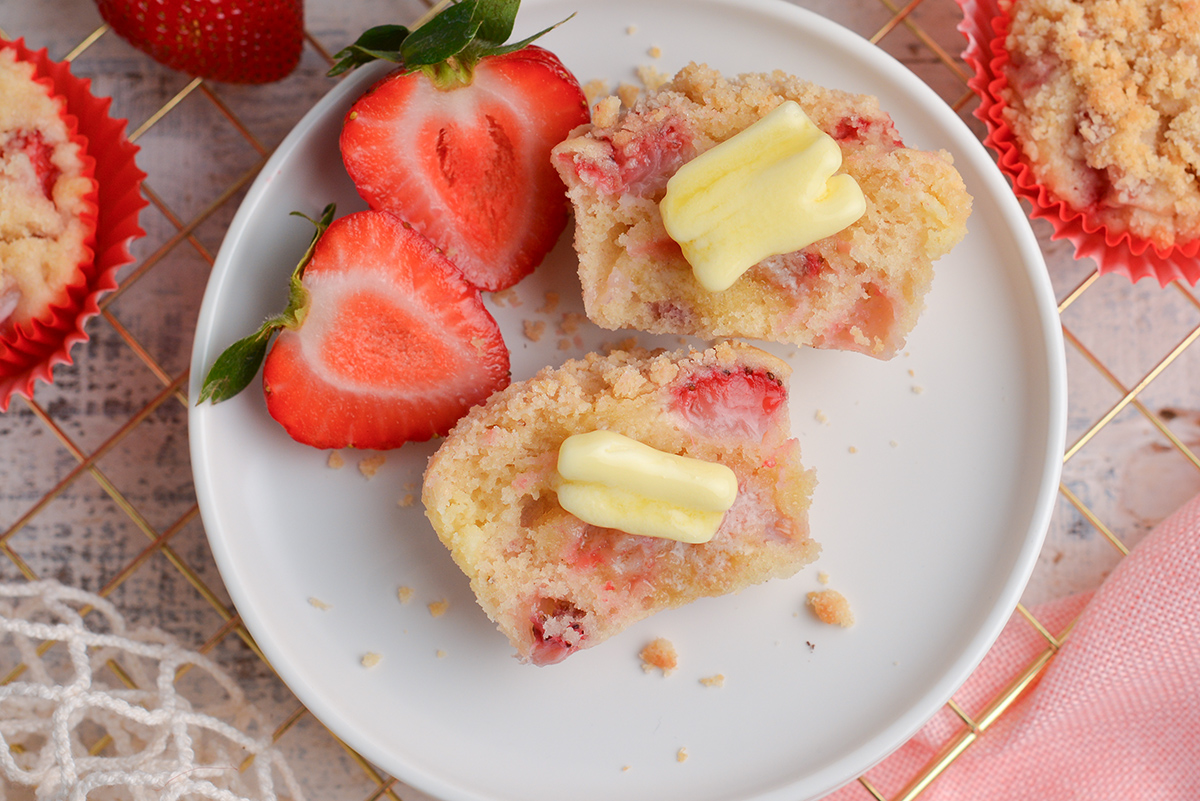 muffin halves on plate with butter and strawberry