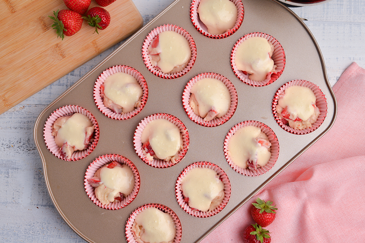 cream cheese mixture on muffin batter in pan