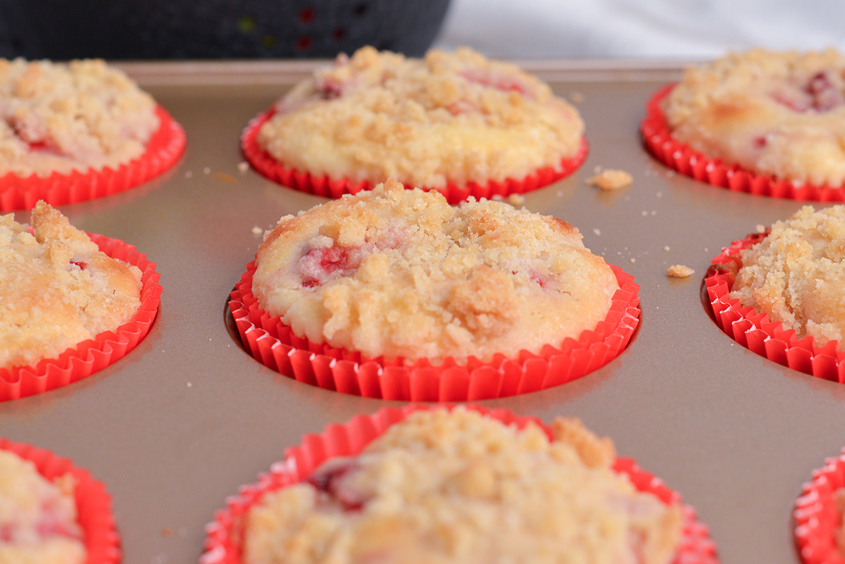 close up angled shot of strawberry cream cheese muffins in pan