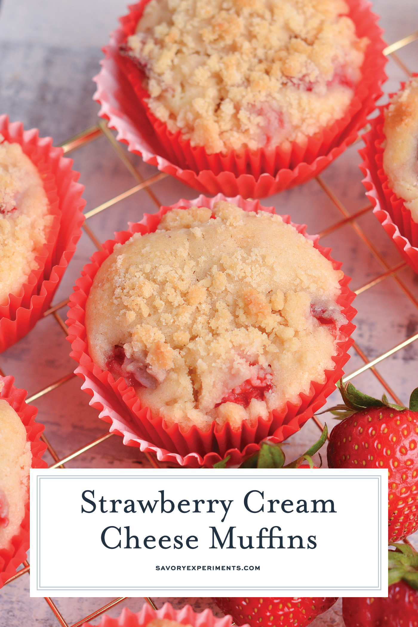 angled shot of strawberry cream cheese muffins on cooling rack with text overlay