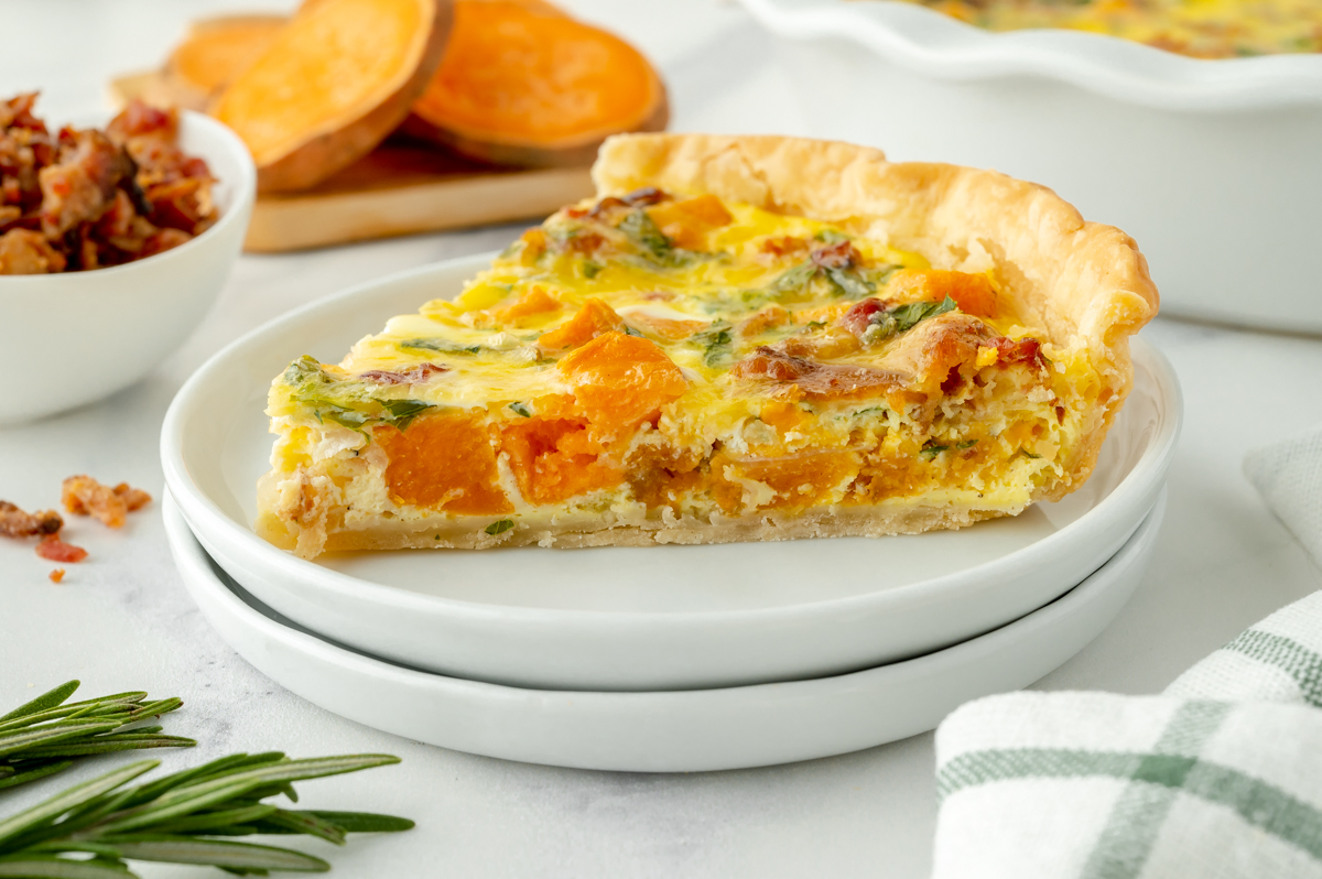 angled shot of slice of sweet potato quiche on plate