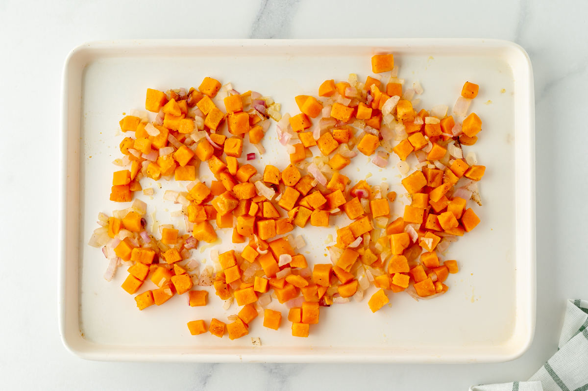 sweet potatoes and onion on sheet pan