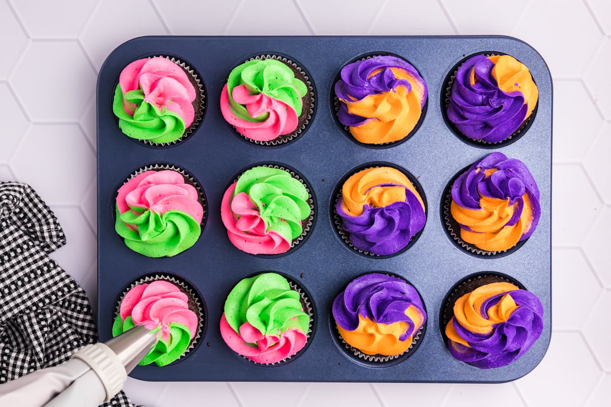 colorful frosting piped onto cupcakes