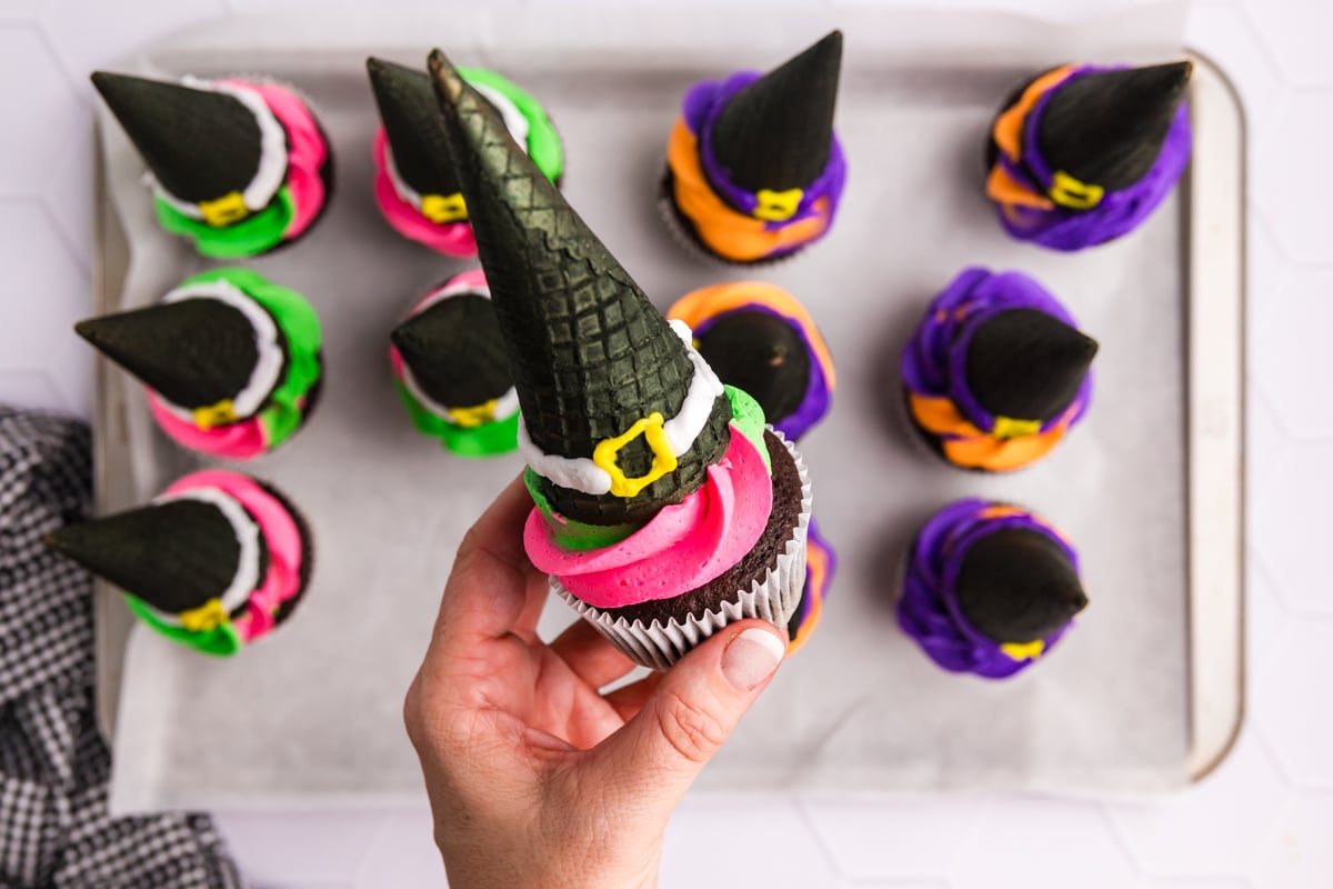 hand holding witch hat cupcake