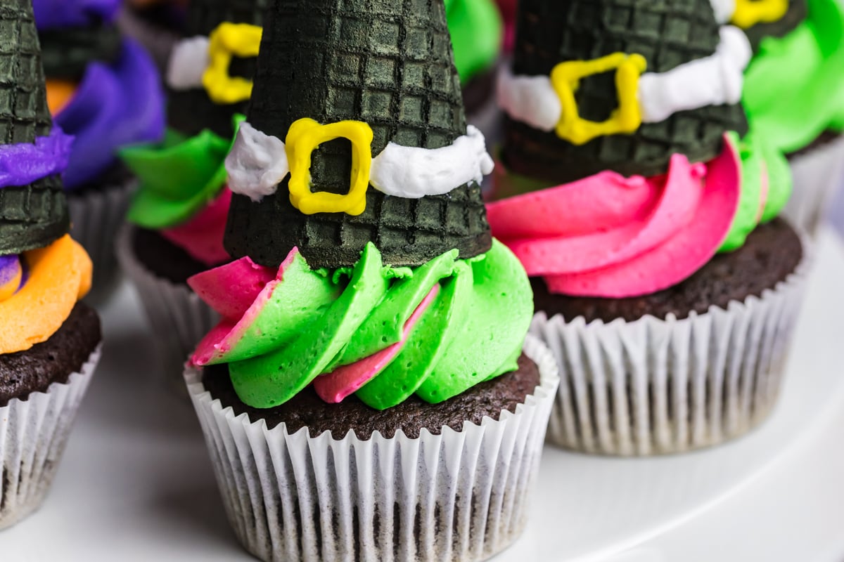 close up of pink and green witch hat cupcake