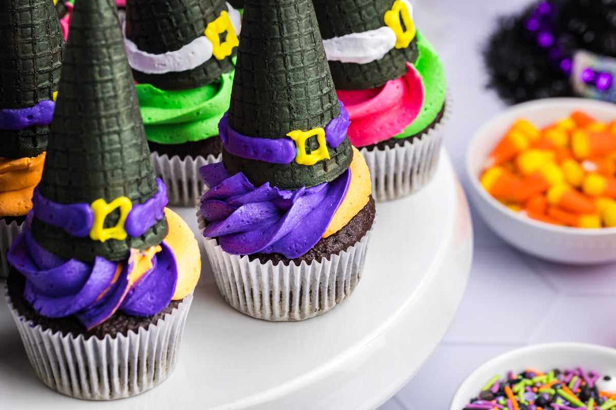 angled close up shot of witch hat cupcakes on