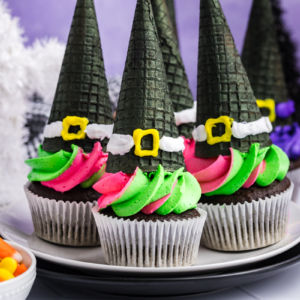 plater of green and pink frosted witch hat cupcakes