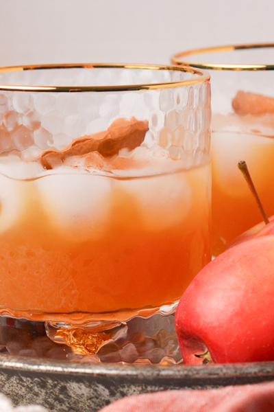 close up straight on shot of two apple cider whiskey cocktails