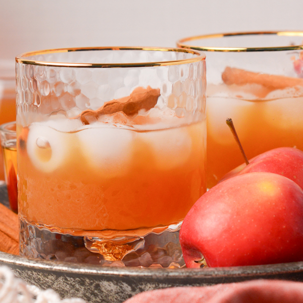 close up straight on shot of two apple cider whiskey cocktails