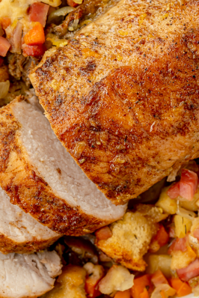 overhead shot of sliced pork tenderloin in dish of stuffing