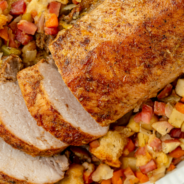 overhead shot of sliced pork tenderloin in dish of stuffing