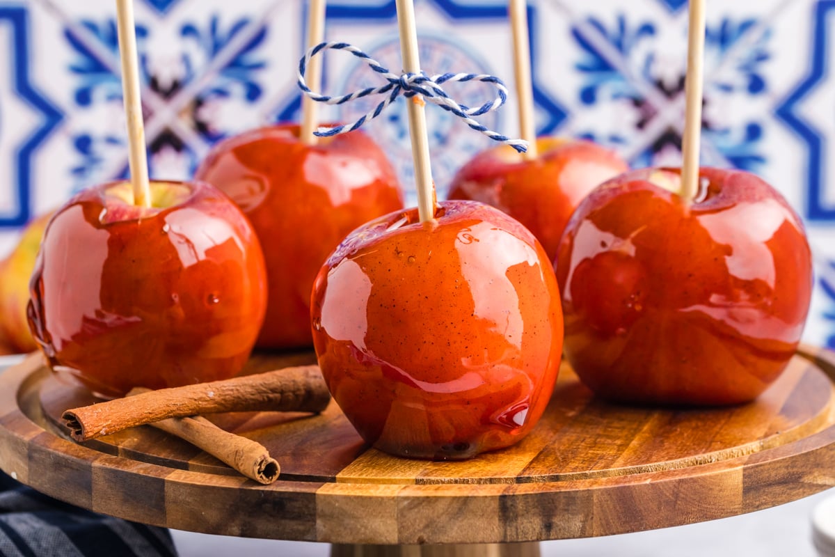 straight on shot of candied apples on wooden board